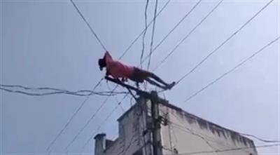 Drunk man climbs electric pole, lies down on wires in Andhra Pradesh